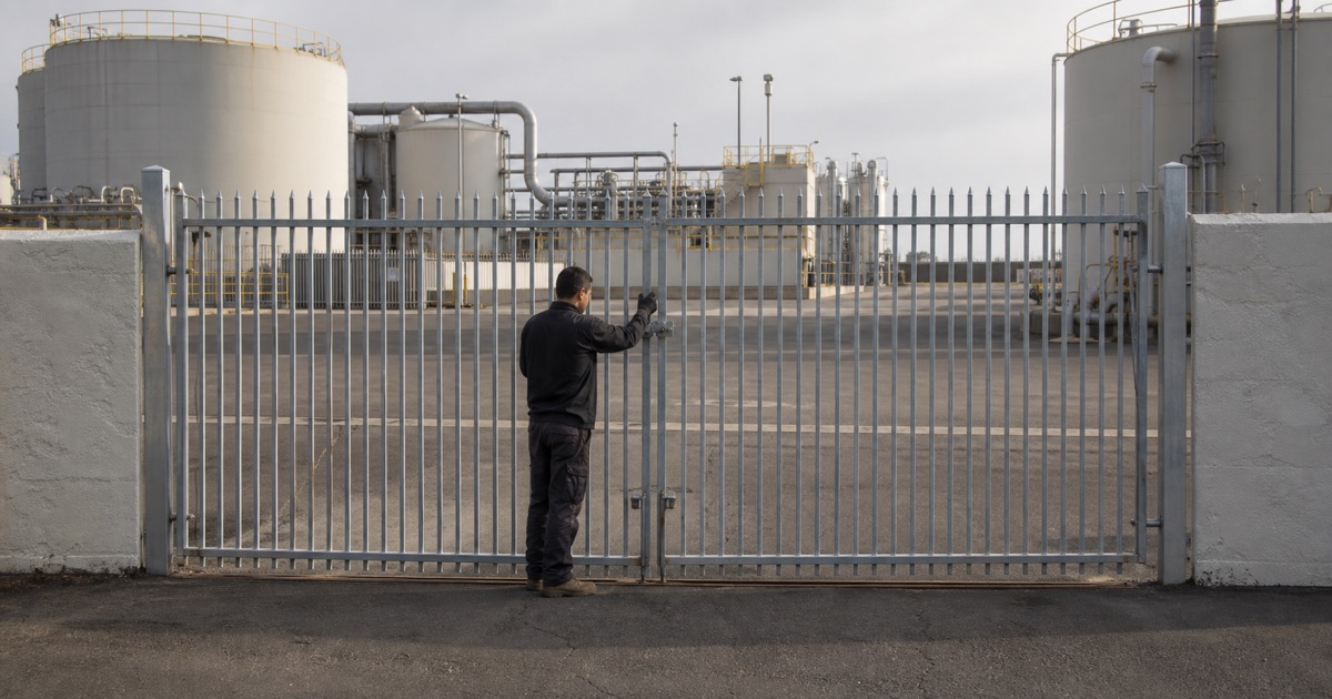 Heavy steel perimeter gate at an industrial yard entrance in Carson, CA
